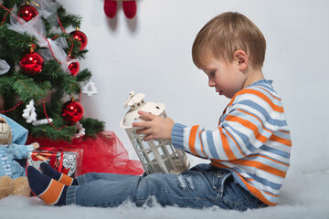 young family at the new year's tree with gifts