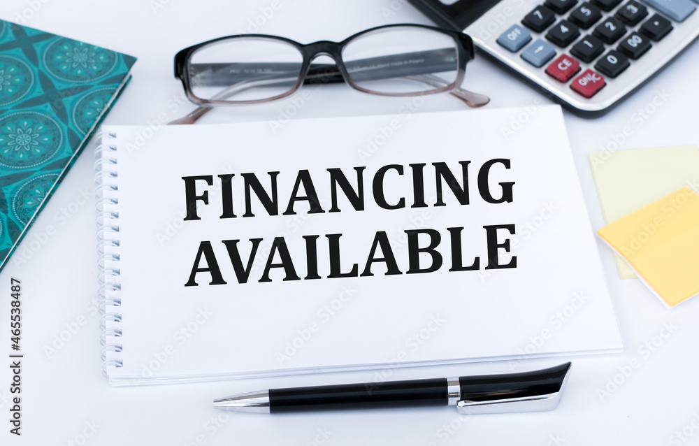 Poster on the notebook is written the text financing available.