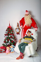 young family at the new year's tree with gifts