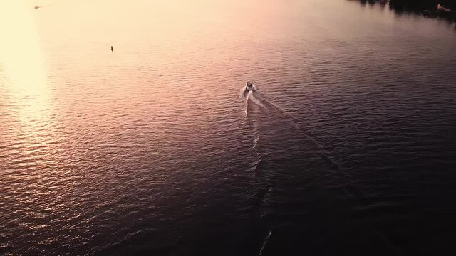aerial city view, yacht on sunset. Drone shot,bird's eye. 4K