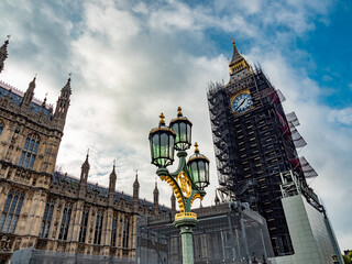 Fototapeta na wymiar Extrerior view of the famous landmark iconic building Big Ben in London surrounded by scaffoldings during the renovations work