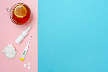 Catch a cold. Flu season. Disease. Flat lay. Medical mask, pills, nasal spray, used wipes, thermometer, and lemon tea. Place for your text. Copy space. Mockup. Seasonal cold concept. Health care. 