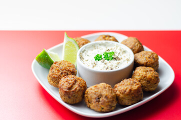 Falafels, gently spiced blend of sweet potato, chickpeas and onion with a sour dip