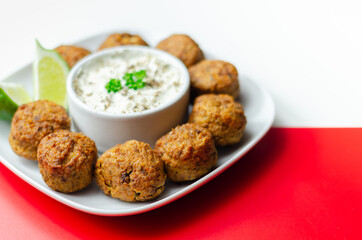 Falafels, gently spiced blend of sweet potato, chickpeas and onion with a sour dip
