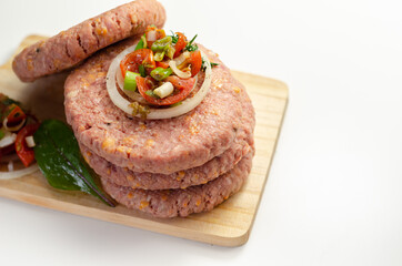 Raw beef burgers blended with caramelised red onion and tangy red Leicester cheese prepared for grilling
