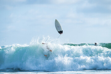 Surfer crashing in the wave in Montanita, Ecuador