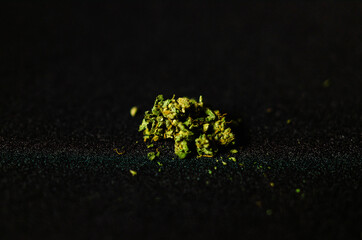 closeup view of marijuana (cannabis) buds. Green, orange earthy tones. Shot on a black background.