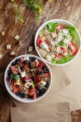 Salad in a disposable glass close-up. Healthy and fast food. Takeaway cafe. Disposable tableware for food safety. Healthy fast food