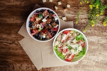 Salad in a disposable glass close-up. Healthy and fast food. Takeaway cafe. Disposable tableware for food safety. Healthy fast food