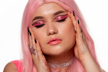 Plus size fashion model, beauty woman with professional makeup glitter on the body and pink hairstyle on white background, closeup studio shot