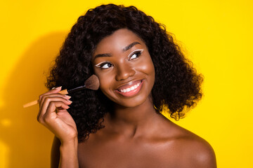 Photo of young happy smiling lovely dreamy african girl look copyspace apply highlighter isolated...