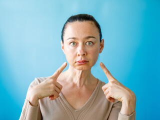 Teeth Problem. Gumboil, flux, bruise and swelling of cheek. Closeup Of Beautiful Sad Woman point...