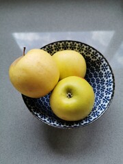 Apples in a blue bowl.