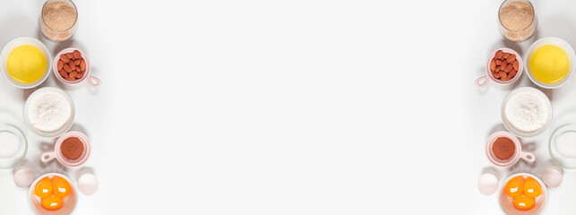 Baking fresh ingredients for making sweet pie, cake, cookies or pancakes on a white background. Top view with copy space