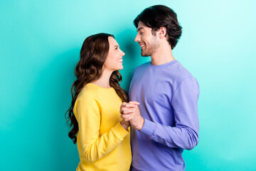 Profile side photo of young attractive couple happy positive smile feelings bonding love isolated over teal color background