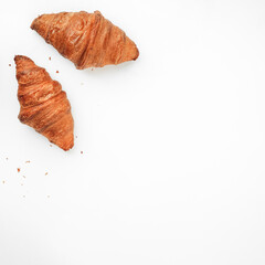 two delicious crispy croissants on a white background