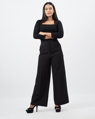 Asian woman full body. Thai woman in a modern chic style stands in white studio with elegant and confident pose. Casting model supporting actor actress. Asian woman fullbody pose in front of camera.
