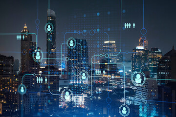 Glowing social media icons on night panoramic city view of Bangkok, Southeast Asia. The concept of...