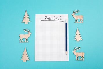Goals 2022, empty paper, christmas time, making plans for the new year, copy space, blue colored background, german language