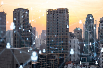 Fototapeta na wymiar Hologram of social media icons over sunset panoramic cityscape of Bangkok, Southeast Asia. The concept of people connections and career opportunities. Multi exposure.