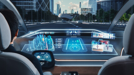 Futuristic Concept: Stylish Businessman Using Navigation 3D App on an Augmented Reality Dashboard with Financial News Broadcast while Sitting in an Autonomous Self-Driving Zero-Emissions Electric Car.