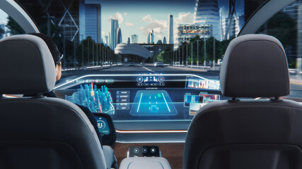 Futuristic Concept: Stylish Businessman Using Navigation App on an Augmented Reality Dashboard with Financial News Broadcast while Sitting in an Autonomous Self-Driving Zero-Emissions Electric Car. 