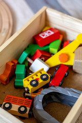 Wooden railroad and trains are in a box. Montessori material. Home schooling concept.
