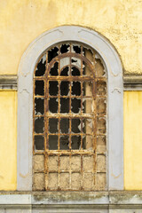 Fototapeta premium beautiful decrepit painted window of an old and abandoned house in the old town of Faro, Algarve, Portugal