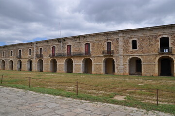 Long, old building with arched windows. Abandoned building of an old military fort.