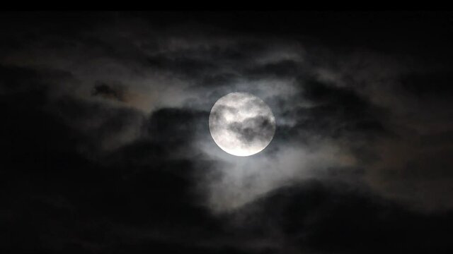 moon in the dark of the clouds