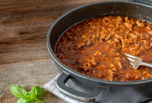 pot with ragout, italian cuisine, cooked with duck breast, root vegetables, tomtoes and herbs