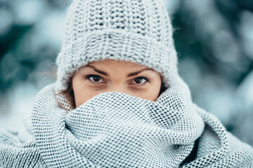 Beautiful young woman wearing scarf and a a hat on a cold winter day