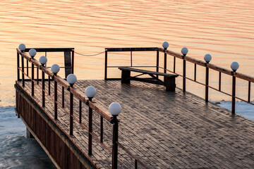 Russia. Spring. Morning. Sanatorium Lunevo. View from the pier of the Volga bank with the rising sun on the water.