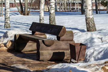 Russia. Spring. Morning. Sanatorium Lunevo. View of a wooden structure standing among the snow in the forest.