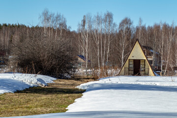 Russia. Spring. Morning. Sanatorium Lunevo. View of the Finnish bath and snow path in the forest.