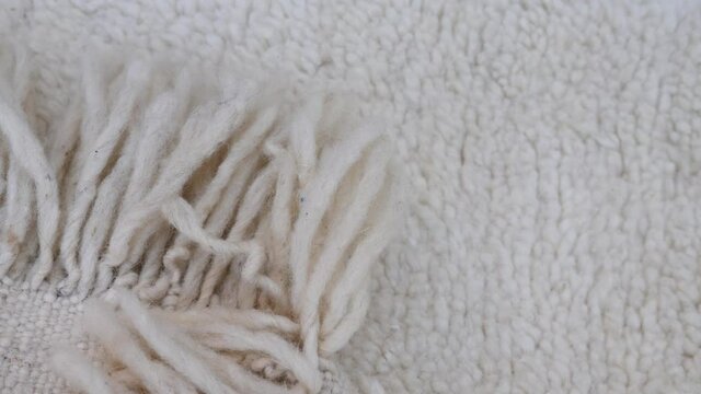 Authentic traditional handmade Moroccan Berber carpet in Beni Ourain style. Morocco home decor, texture background footage.