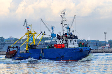 The fishing vessel returns to the harbor in the evening