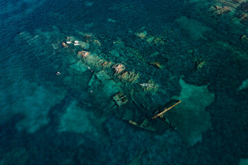 View from above, stunning aerial view of some people swimming and snorkeling around the Chrisso...