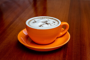 Hot cappuccino coffee cup on wooden table. food and drink concept