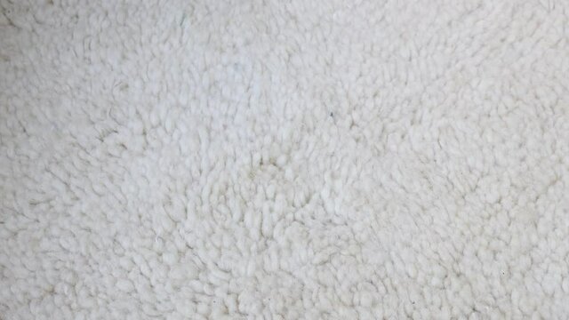 Authentic traditional handmade Moroccan Berber carpet in Beni Ourain style. Morocco home decor, texture background footage.