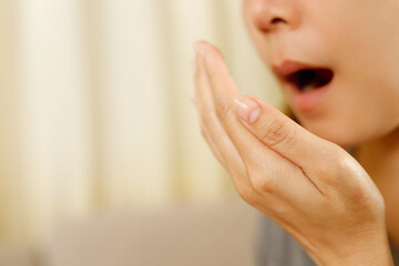 Women have bad breath caused by swollen gums.