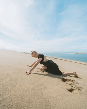 Graceful woman lying in sandy desert