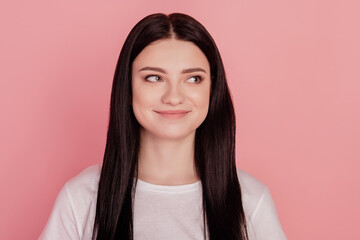 Fototapeta premium Photo of dreamy inspired cheerful lady look empty space isolated on pink color background