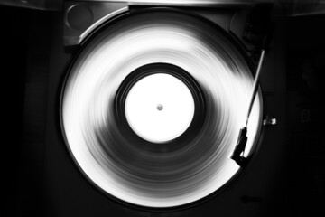 Abstract black and white image of a turntable for vinyl records. Long shutter speed. Motion tracks.