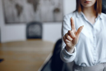 Businesswoman hand pushing screen at the office