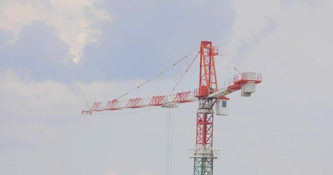 Construction crane. Tower crane at a construction site. Construction of a multi-storey residential building.