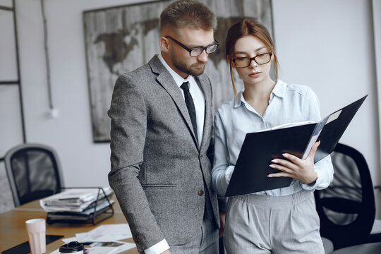 Man and woman read a business contract