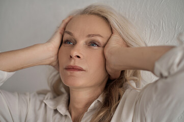 Fototapeta premium Serious sad female pondering over a problem