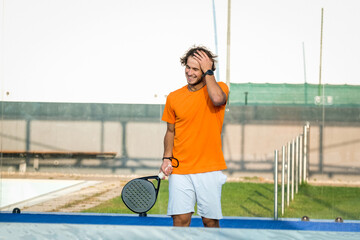 Portrait of a disappointed padel player after a lost to padel or tennis game - Handsome player...