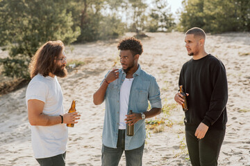 Three men of different nationalities are trying to get along, find common language explaining with...